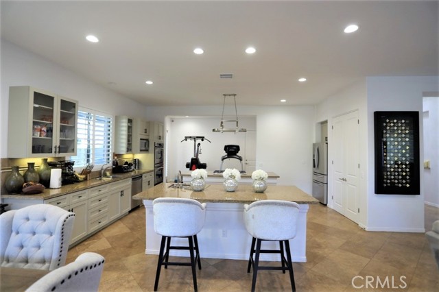 80868 Song Bird Avenue Indio, California Amazing opportunity to own a contemporary style home at montage at Santa Rosa. This 4 Bedroom, 4 bath former model home with 2,961 Square Feet has so many beautiful modern touches you need to see in person to appreciate. Custom Lighting fixtures & ceiling fans. Custom Wet bar and entertainment cabinetry with custom contemporary light and metallic feature wall. French doors, shutters, Large over 13,000 SF North facing lot. Private pool and spa with rear yard detached casita. Outdoor built in BBQ and outdoor fireplace make this a fantastic place to spend Desert evenings. Large Kitchen with 2 separate Islands, granite counters, large double door pantry with on trend white cabinetry. Bonus room off of the kitchen for workout room, office or additional dining area. Lots of parking with 3 car garage, and RV space, custom diamond shape driveway with extra concrete pad to accommodate 4 cars on the driveway. RV Gate and extra space too! Exterior recently painted with custom paint color palette. Low HOA fees and this community does cooperate with short term and music festival rentals! This would make a fantastic full time residence, part time home or an amazing Coachella or short term rental!