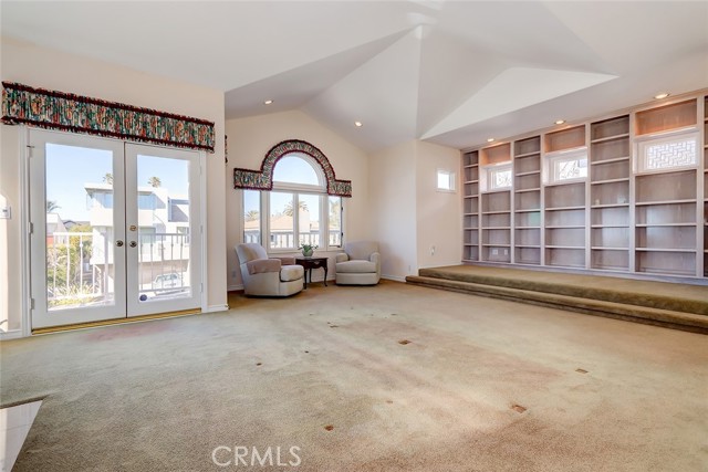 Living room and library area with French doors leading out to front ocean view patio, relax and enjoy!