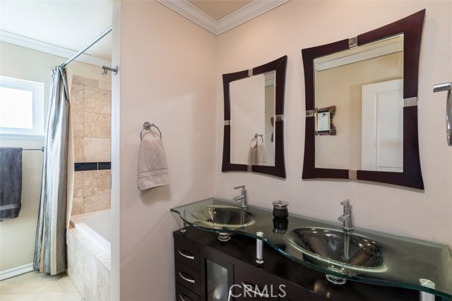 Upstairs bath in main hallway also with lush travertine flooring.