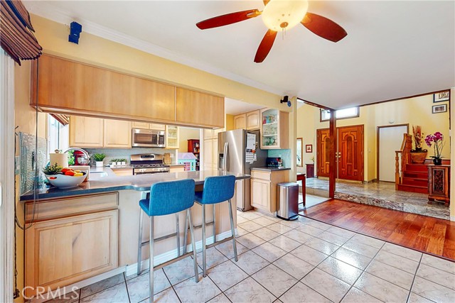 Breakfast bar off Kitchen has speakers and celing fan above