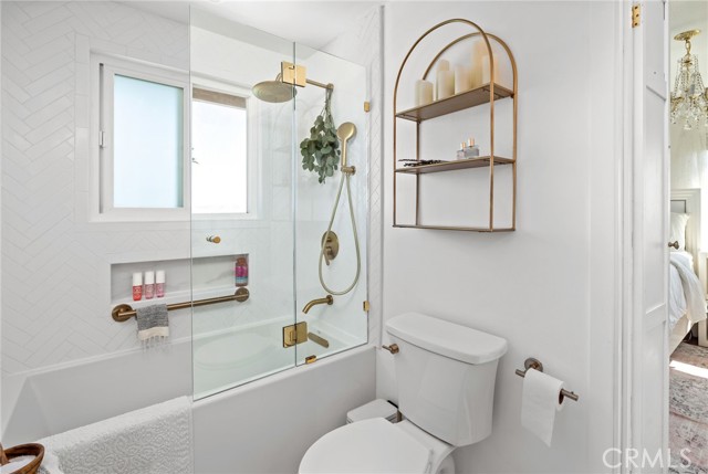 Beautifully remodeled Jack & Jill bath with stunning herringbone tile and a spa-like ambiance.