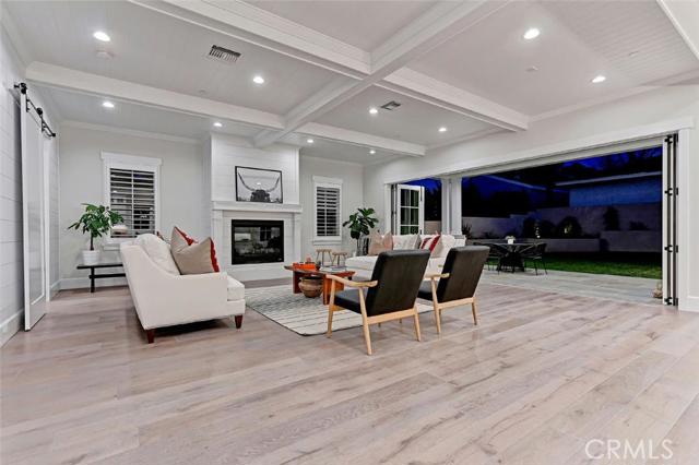 Accordion-style french  doors open to backyard and covered patio