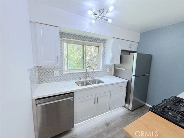 Completely upgrade kitchen with Quartz counter tops and vinyl floors and appliances. Under cabinets lighting.