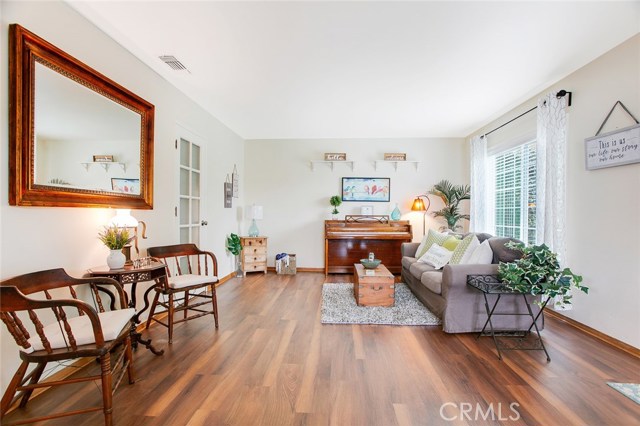 Sunlit Living Room exudes brightness and cheerfulness with double-paned glass windows and a Farmhouse-inspired interior design.