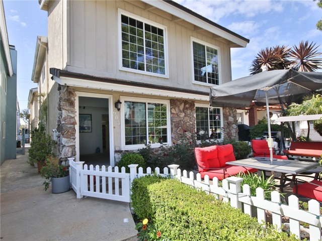 Front of duplex showing entry to front unit and patio