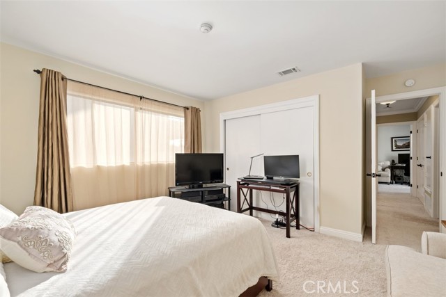 2nd bedroom/office with window facing south brightly lit and large closet