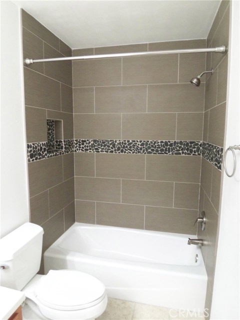 Shower with Stone Tiles and River Rock Inlay