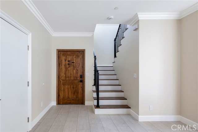 Entry & stairs leading to 3 bedrooms, 3 bathrooms & laundry room.