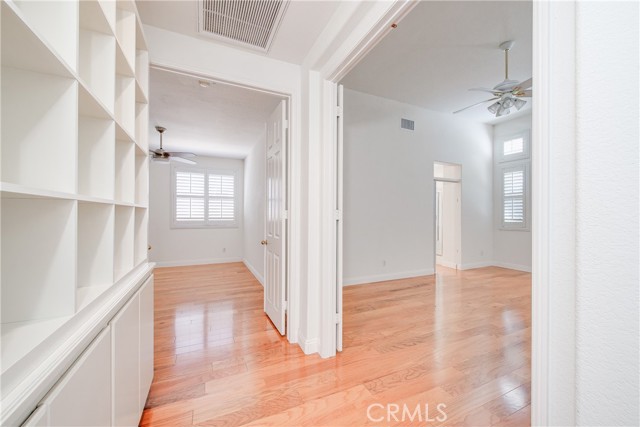 Hall with built-in cabinets. Master bedroom on right and 2nd bedroom on left.