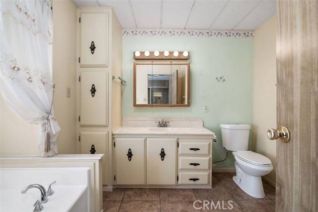 Primary en-suite bathroom features a relaxing soaking tub and more than ample storage.