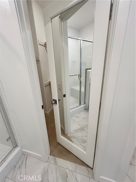 Primary closet with full glass mirror