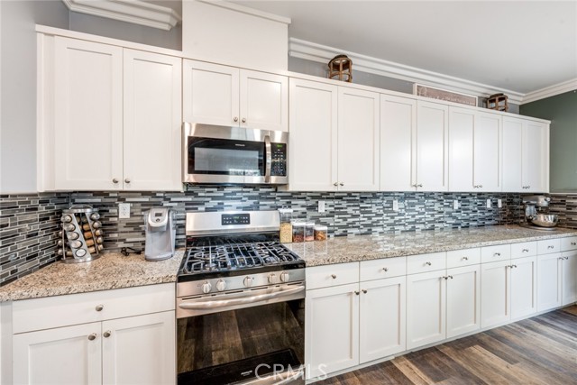 Kitchen with granite countertops and backsplash