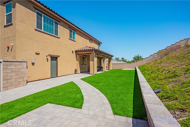 Your back yard patio has recessed lighting, and recently got new astro turf with brick pavers for a no mow back yard.