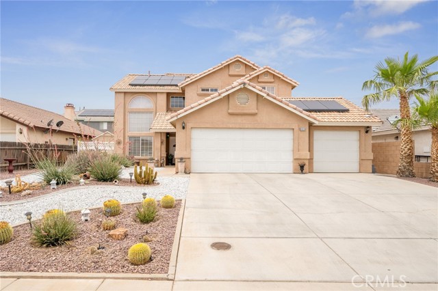 8936 Concord Court Hesperia, California This beautiful 4 bedroom pool home is a dream home! You'll appreciate the beautiful desert landscape upon arriving. The lovely living room features vaulted ceilings, plenty of natural light throughout. The formal living room flows onto the formal dining room. Downstairs you'll find a spacious bedroom with plenty of closet space, a full bath and a laundry room with lots of cabinet space. The hallway leads to the family room with a fireplace that flows to the spacious kitchen that features granite countertops, plenty of cabinets, a mini pantry and a desk area. Upstairs are two bedrooms a full bathroom and a gorgeous master suite. The master bath has dual sinks, large bathtub with separate stand-up shower and a large walk-in closet with plenty of shelves. The backyard has a breathtaking 6' pool with a waterfall feature that's next to the large patio that's surrounded by the beautifully stamped concrete and vinyl fencing adds such a nice touch to this beautiful backyard. If you like to entertain, this is ideal for you! Additional features: Matching shed on side of house, spacious 3 car garage, ceiling fans throughout, drought resistant landscaping throughout, solar panels for a great savings! Don't miss out!