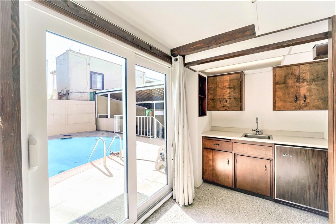 The wet bar which is located close to the rear yard and pool, is perfect for entertaining.