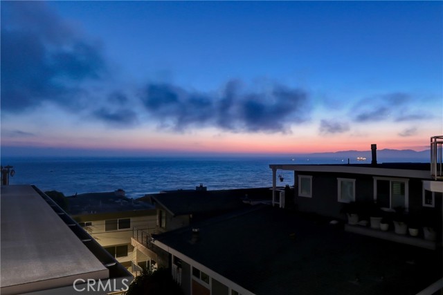 View of Santa Monica Bay at dusk from 3rd floor deck that runs the full western side of the home.