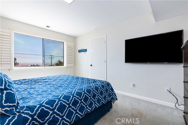 Downstairs bedroom. Door leads to bottom of interior stairs near main front entrance.