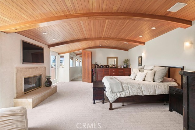 Master bedroom looking West with dramatic boat bottom and glulam ceiling continuing ...