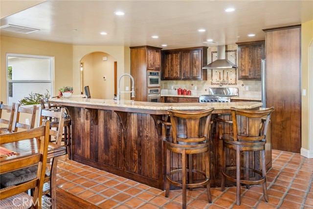 The kitchen island offers an expansive bar area ideal for serving food, having a casual meal, or conversating with the cook.