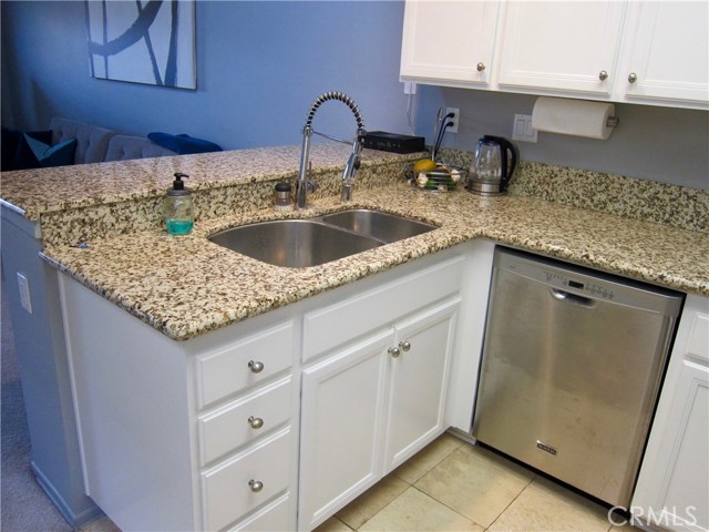 Beautiful granite counter tops, travertine floors, upgraded stainless steel sink and faucet and dishwasher!