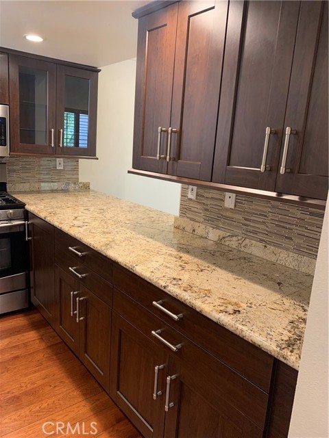 Long Kitchen granite counters and nice cherrywood cabinets