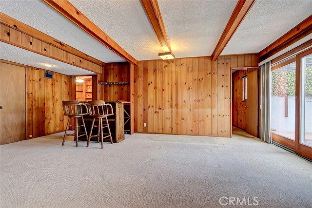 Downstairs family room opens to the yard and pool