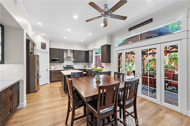 The dining area flows seamlessly between the kitchen and the family room. Check out the built-in cabinets and buffet to the left and french doors leading to your outdoor living space.