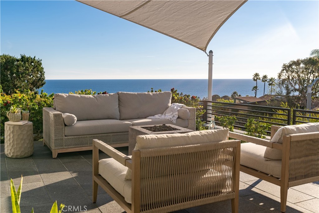 This exquisite Laguna Beach ocean-view residence epitomizes the essence of California Coastal Living at its finest. Impeccable style and sophistication define this expansive single-level home, featuring 3 bedrooms and 3 bathrooms, which underwent a complete transformation in 2017 by the renowned Laguna Beach architect, Morris Skenderian.
The gourmet kitchen, elegantly appointed, boasts a substantial center island, a 6-burner chef's stove, a subzero refrigerator, and a host of other amenities. The primary bedroom is graced with a generously sized walk-in closet, thoughtfully enhanced with upgraded closet organizers.
Step outside, and you'll discover enchanting outdoor spaces designed for entertaining while soaking in the breathtaking sunset vistas. This prime South Laguna location offers the convenience of being within strolling distance to Aliso Beach, the picturesque Treasure Island Park, and the world-renowned Montage Resort. Not to be overlooked, the area also boasts an array of excellent restaurants and the enticing 9-hole canyon golf course at Ben Brown's.