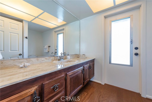 Primary bathroom with door leading to deck