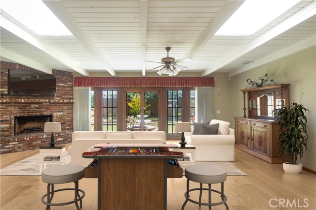 Family room, with fireplace, overlooking back yard through French doors and windows