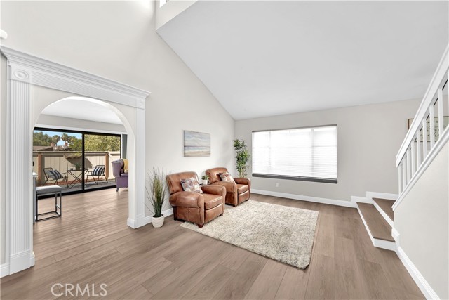 Living Room with Arched Passage to Kitchen and Family Room