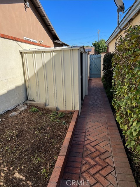 Right side yard with two sheds for storage