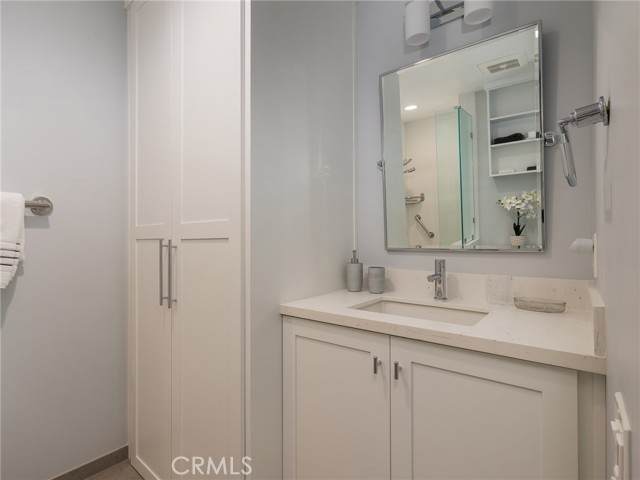 Second elegant bathroom - quartz counters, stackable washer and dryer in closet.