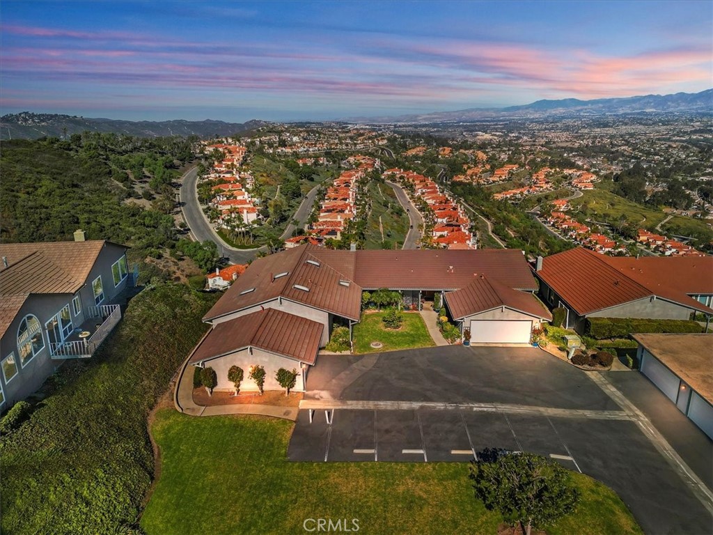 Discover coastal elegance in this stunning 2 bedroom, 2 bath, single-level home high atop Monarch Summit’s ridge in Pacific Island Village III.   From the moment you enter, enjoy UNOBSTRUCTED PANORAMIC VIEWS, vaulted beam ceilings, and an open floor plan with a cozy fireplace. The gourmet kitchen features stainless steel appliances, a new cooktop, granite countertops, white cabinets, and a walk-in pantry with interior laundry. Three skylights and dual-pane windows fill the space with natural light. Step onto the expansive outdoor deck, perfect for entertaining or relaxing. Additional highlights include a 2-car attached garage with guest parking just steps from your front door and resort-style amenities: pool, spa, and clubhouse. Minutes from world-class beaches, dining, shopping, hiking trails, and golf courses, this home offers the best of Southern California living.