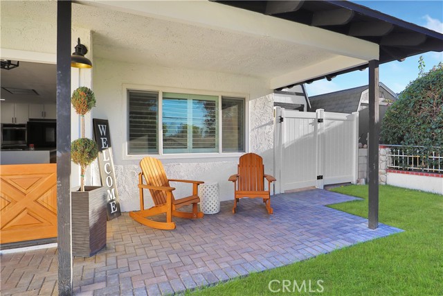 Welcoming, covered front porch with pavers