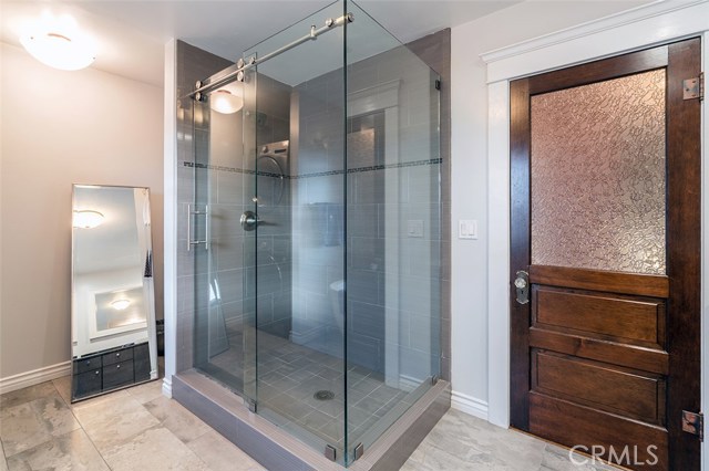 Upstairs shower with view to the closet space available behind the shower wall.