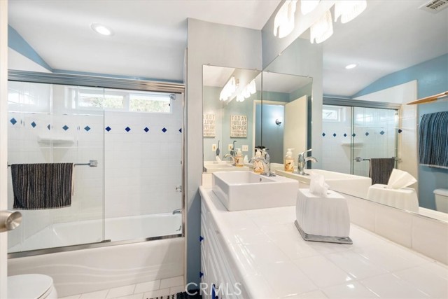 Newly upgraded guest bath with tile counter tops and tile shower