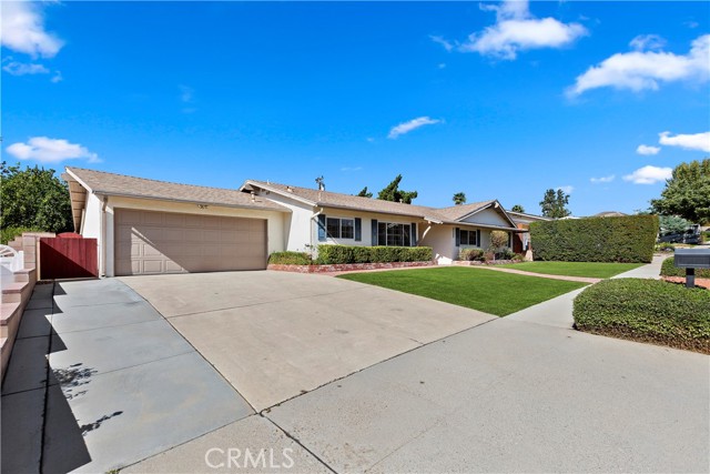 Driveway & Garage - The wide driveway has space on the side to park additional cars without blocking the garage.