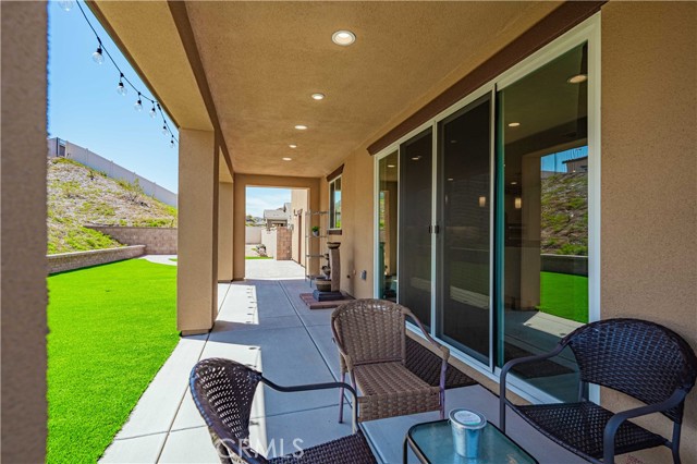 Pocket sliding glass doors open to your back yard patio with recessed lighting. Concrete underneath makes it easasy to clean. Sellers just installed astro turf and brick pavers for a no mow/easy to maintain back yard.