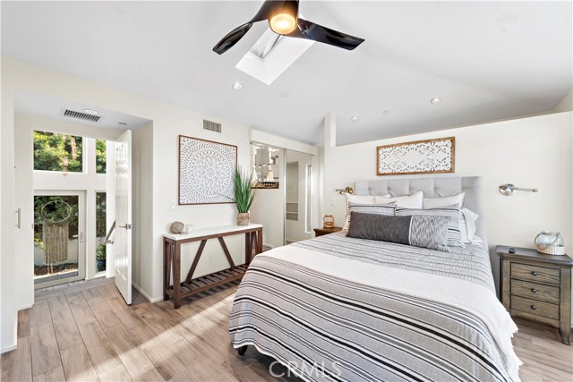 Primary bedroom with wood look tile floors throughout