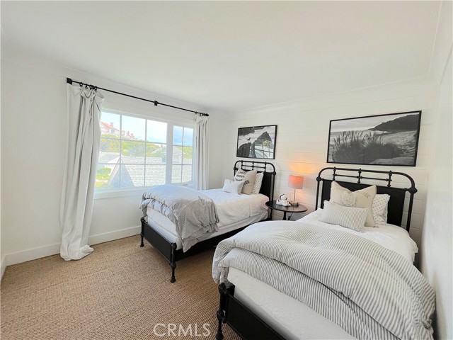 Light filled bedroom three with twin beds.