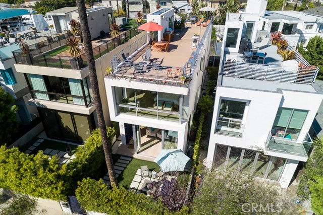 651 Oxford Avenue Venice, California This sun drenched, architectural masterpiece in the heart of the highly desirable Silver Triangle area of Venice is SoCal living at its finest! Entering through the front gate, you’ll find a private & lush seating area with built-in fire pit, perfect for a glass of wine on those cooler nights. Inside, open up the 11 foot Fleetwood sliding doors for an indoor-outdoor experience. An open floor plan combined with floor-to-ceiling windows creates a bright and calming environment. High-end stainless steel appliances, 6-burner range, custom cabinets, and a beautiful tile backsplash sets this kitchen apart from the rest. Three bedrooms, three full bathrooms, and a separate laundry room are located on the second level, including the master suite with a full wall of floor to ceiling windows perfect for watching the sunset. An extensive walk-in closet and spacious en suite bath with walk-in shower completes the master suite. The second bedroom features plenty of built-in storage, a pass-through closet and en-suite bath with walk-in shower and separate soaking tub. A third room with built-ins can be used as an office or playroom. A huge rooftop deck completes the entirety of the third level with sparkling views of downtown, endless palm trees, and the Santa Monica mountains. Directly located in between the famed Venice Canals and Marina Del Rey harbor. Walking distance to the beach and the iconic Venice Pier as well as a multitude of restaurants and shops.