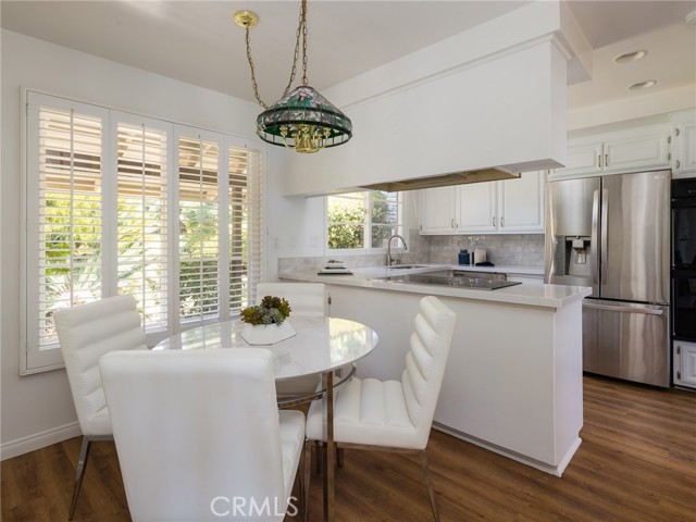 Kitchen with stainless appliances and nook.