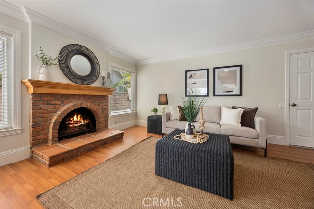 The family room boasts a charming brick fireplace, elegant crown molding, and convenient direct access to the garage