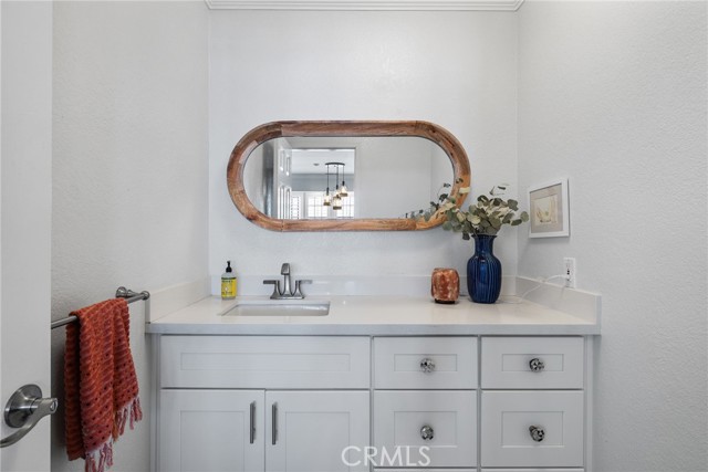 Main level powder room. Remodeled in 2019 with quartz countertops.