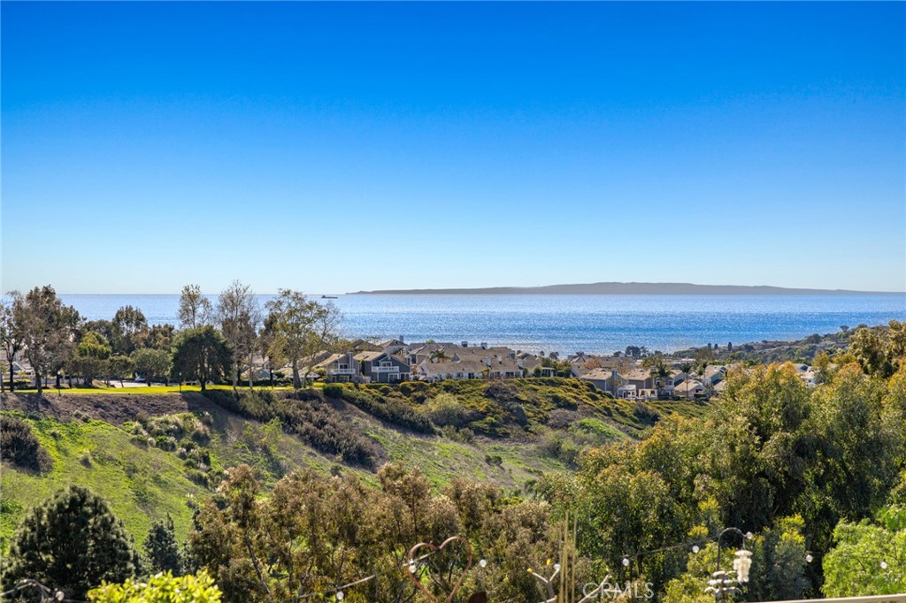 8 Ponders End Laguna Niguel, California Ocean View Beacon Hill Pointe home with dual master bedrooms (one on main floor). This 4 bedroom, 3.5 bath home is situated in a wonderful spot of a single loaded cul-de-sac. Angled just the right way on the lot to take in blue water and blue sky views as well as a serene hillside and canyon views, extra special & colorful during a Spring super bloom. This traditional floor plan has a grand double door entry bringing you into the living and formal dining areas both with cathedral ceilings. The remodeled and upgraded kitchen has new appliances. Enjoy breakfast while sitting at your expansive, center island or in your kitchen nook looking out at the scenic garden view.The large back yard has been totally redone with beautiful pavers and an added spiral staircase to the deck upstairs for maximizing sunset/ocean views! Back inside, you can cozy up to the warm fireplace with white washed brick accents in the family room and be drenched in sunlight from the skylights above. The main floor also hosts a half bath, a large master bedroom with glass sliders going out to the back patio, a full en suite bathroom and a three car garage with an extra long driveway. Glide up the stairs to a modified master bedroom with ocean views, attached deck and addition of a large master bathroom. Two additional bedrooms and a full bath complete the upstairs.Upgraded flooring, repiped with PEX and newer HVAC system. Enjoy all Beacon Hill has to offer including 3 swimming pools and spas and 6 lighted tennis courts.
