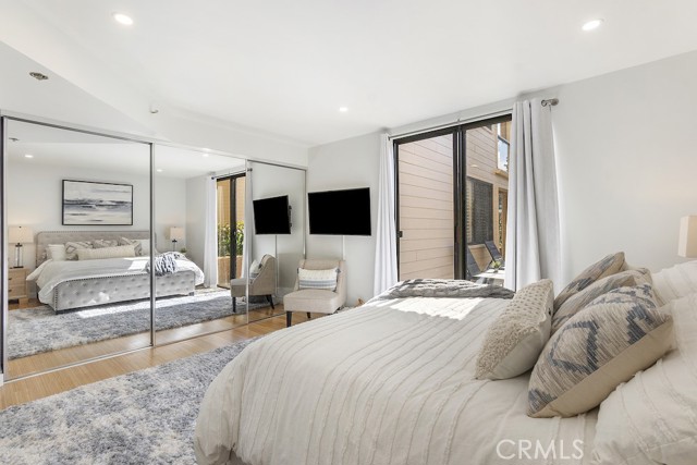 Master bedroom has mirrored closet doors, separate walk-in closet, and access to the patio