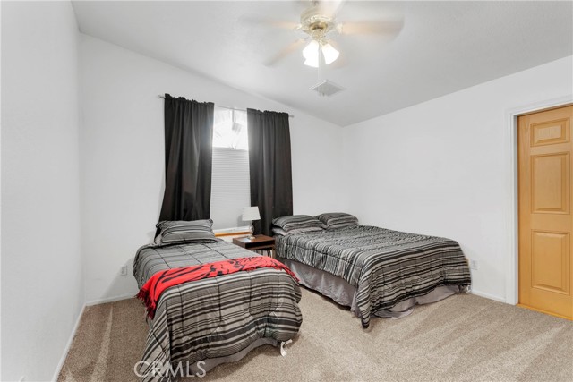 Guest Bedroom 1 with door leading to side yard