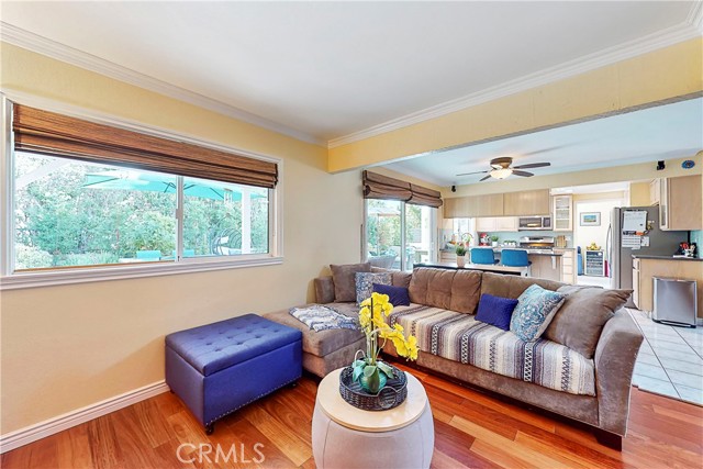 4th bedroom has been converted to a family room with wood flooring next to kitchen