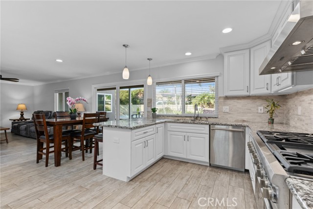 Plenty of white shaker style cabinetry with soft closing drawers, undermount lighting and beautiful exotic granite countertops!